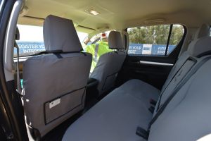Black Duck Seat Covers suitable for  8GEN Toyota Hilux HX152ABC showing the map pockets on the rear of the front seat covers.