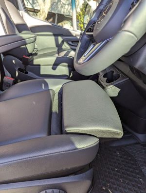 SHOWS ADJUSTABLE THIGH SUPPORT